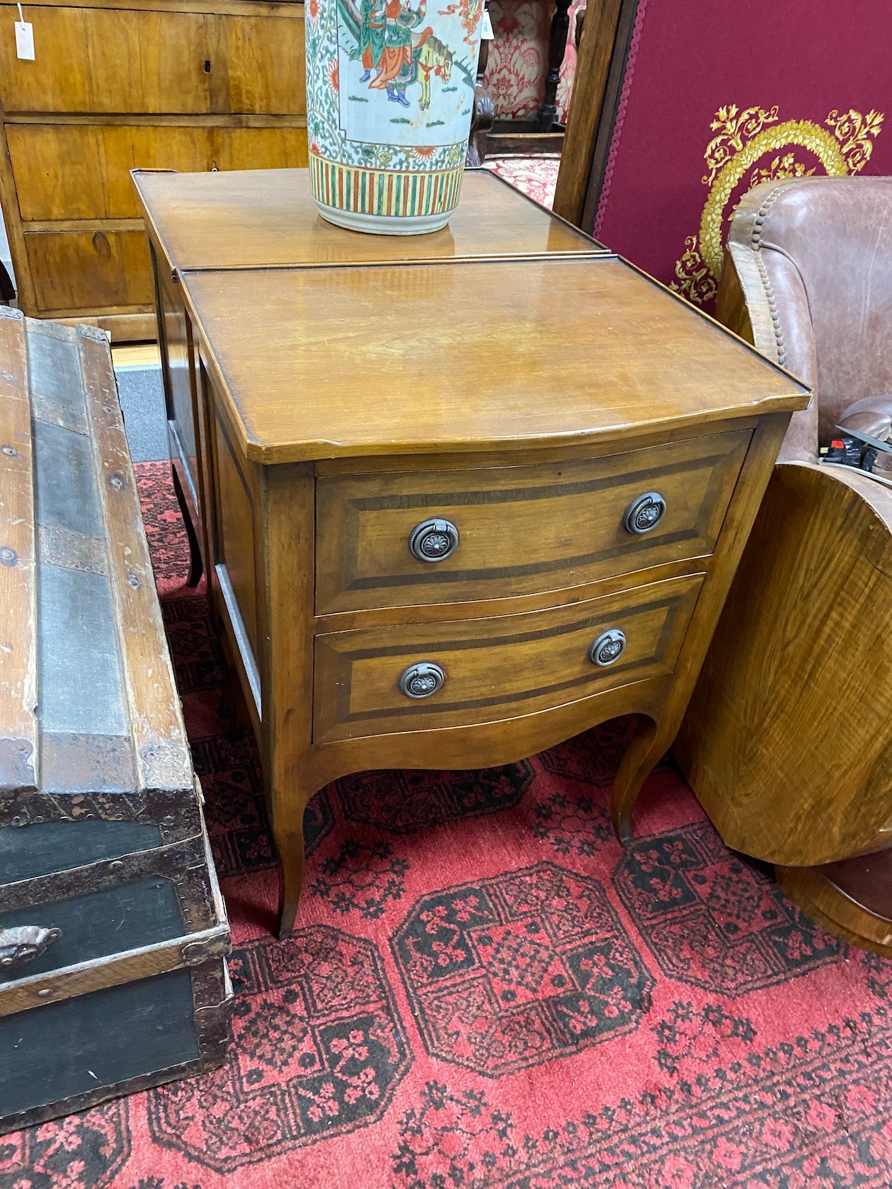 A pair of reproduction serpentine two drawer mahogany bedside chests, width 56cm, depth 41cm, height 72cm